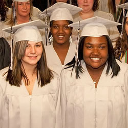 high school graduates wearing caps and gowns