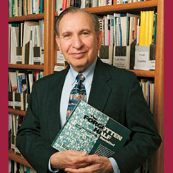 Photo of the late Samuel Halperin holding a copy of his report "The Forgotten Half"