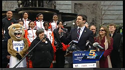 Screen Cap from news story: Outdoor press conference with students, educators, and city council member.