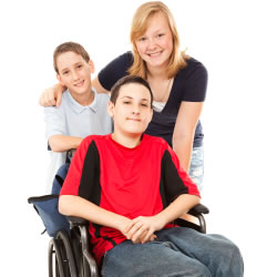 sister with her two brothers, one of which is in a wheelchair