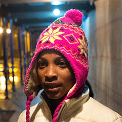 Head and shoulders of 11-year-old Dasani outside at night wearing a pink winter hat